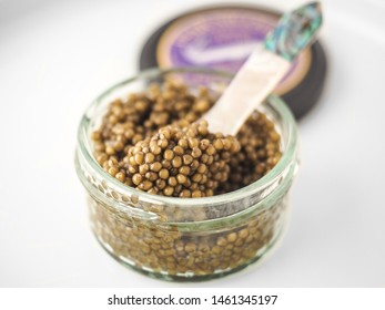 A Closeup Of Golden Osetra Caviar In A Jar With Blurred Background