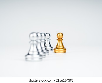 Close-up the golden pawn chess piece moving out from the line of silver pawn chess pieces on white background, stand out from the crowd. Leadership, Unique, influencer, difference concept. - Shutterstock ID 2156164395
