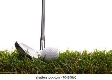 Closeup of a Golf Ball and Iron in tall grass with a white background.
