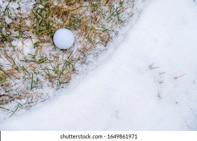 Close-up of a golf ball on the snow.