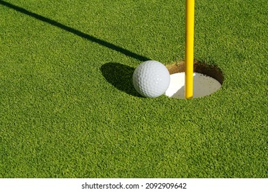 Close-up Of Golf Course Green, Flag Pin And Ball.