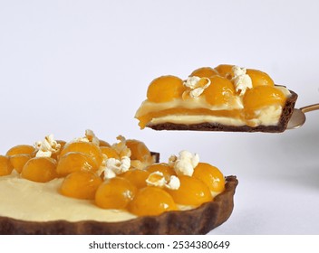 Close-up of a gourmet slice of mirabelle plum tart with insert and sweet cream in a chocolate tart base. - Powered by Shutterstock