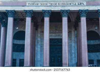 Close-up of a grand entrance featuring towering columns and an ornate bronze door, exemplifying neoclassical architecture and cultural heritage. The scene captures architectural grandeur - Powered by Shutterstock