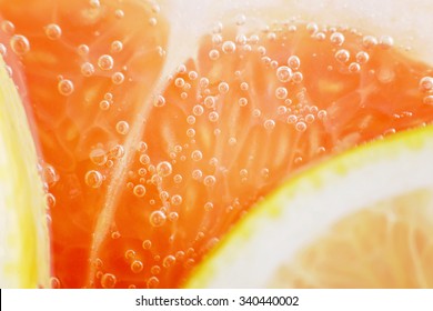 Closeup of grapefruit pulp. Refreshing grapefruit drink, cocktail. Fruit, grapefruit, tropical fruit. Grapefruit and lemon soda. Freshness, flavor. Sweet and bitter taste. Background, texture