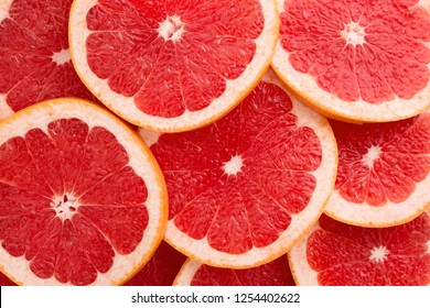 Close-up Grapefruit slices abstract background in Living Coral color of the Year 2019. Bright summer texture. - Powered by Shutterstock