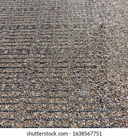 A close-up of a graveled path within a mesh in the Poundbury town in England