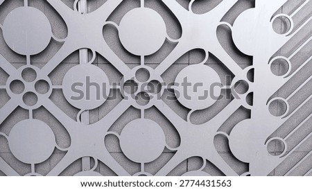 Close-up of a gray abstract geometric pattern featuring circles and lines in a repetitive design