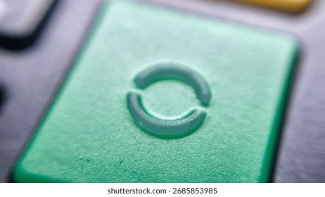 A close-up of a green button featuring a circular refresh symbol, suggesting the concept of restarting or reloading. Ideal for technology, interfaces, or digital communications.