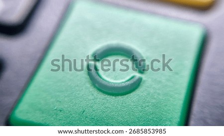 A close-up of a green button featuring a circular refresh symbol, suggesting the concept of restarting or reloading. Ideal for technology, interfaces, or digital communications.