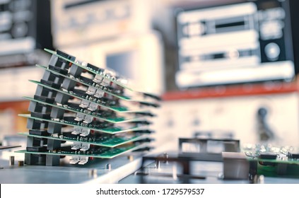 Close-up green computer microcircuits are stacked on top of each other to prepare for the further production of computer in factory for production of office equipment and computers. High tech concept
