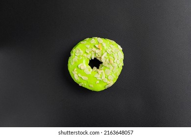 Close-up Of Green Doughnut Or Donut Isolated On A Black Background. Food Background.