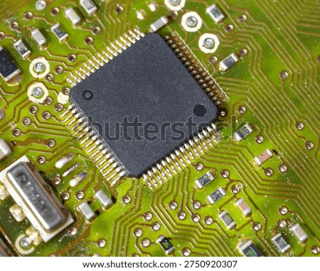 Close-up of a green electronic computer board with microchips.