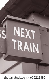 Closeup Of Green Next Train Sign In Black And White Sepia Tone