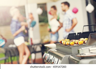 Closeup of grilled shashliks and hamburgers on grate