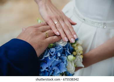 Closeup Groom And Bride Are Holding Hands At Wedding Day And Show Rings.