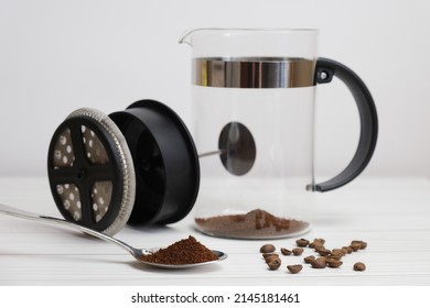 Close-up of ground coffee in a metal spoon. Making coffee in the French press. Selective focus on spoon, blurred background. - Powered by Shutterstock