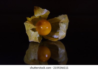 A Closeup Of A Groundcherry (physalis) Isolated On A Black Surface