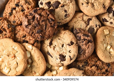 Closeup of a group of assorted cookies. Chocolate chip, oatmeal raisin, white chocolate fill the frame.