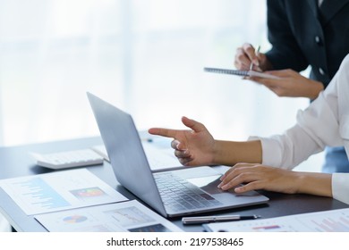 Close-up Of A Group Of Business People Working Together To Plan A Marketing Strategy Using A Laptop To Analyze The Balance Sheet Report, Quarterly Financial Statement.