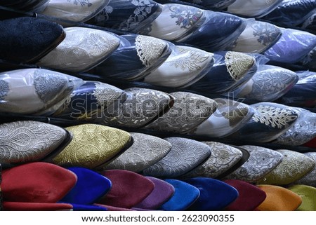 Closeup of a group of colorful handmade shoes in a shop inside the medina of Marrakech, Morocco