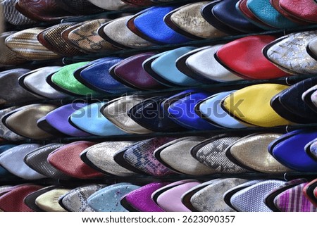 Closeup of a group of colorful handmade shoes in a shop inside the medina of Marrakech, Morocco