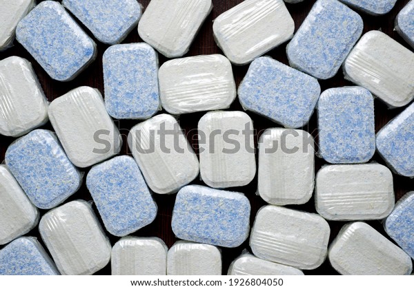 Close-up of a\
group of dishwasher detergent\
tablets.