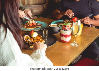 A Closeup Of A Group Of Friends Lunching With A Glass Of Champagne In The Restaurant