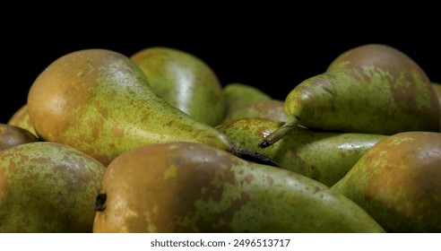 A close-up of a group of green pears. The pears are arranged in a cluster, and some are slightly out of focus. The background is a dark, almost black color, which makes the pears stand out. - Powered by Shutterstock