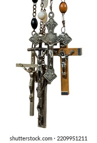 Close-up Of A Group Of Metal And Wooden Crucifixes And Rosary Beads Isolated On White Background, Photography.