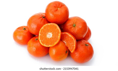 Closeup  Of A Group Ripe Orang Mandarin, Clementine Cut Half Slice And Whole Isolated On White Background, Cross Section Organic Tangerines Two Piece Set On Orange Pile. Tropical Fruit With C Vitamin