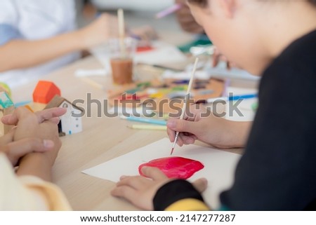 Closeup group of student sitting and studying and learning drawing with teacher together in classroom at the school, pupils creativity for drawing in course, back to school, education concept.