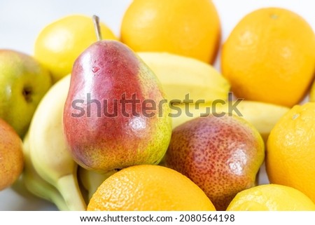 Close-up group of various fruits - pears, bananas, lemon and oranges. Ripe bright fruits - sources of vitamins and antioxidants. Healthy food