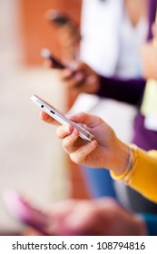 Closeup Of Group Young People Using Smart Phone