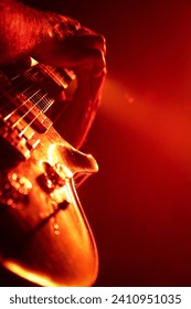 Close-up of a guitar during a live rock concert.