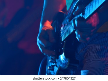 Closeup of a guitar player - Shutterstock ID 247804327