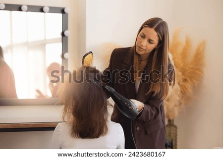 Close-up of hair dryer use hairdresser, concept barber salon, female stylist.