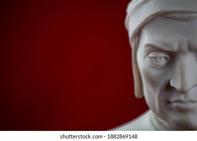 Close-up of half face about ornament depicting Dante Alighieri in plaster on a red background - Shutterstock ID 1882869148