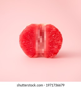 Closeup A Half Of Grapefruit with blurred censored squares on a pink background place for text. Sex Concept Of Vagina Symbol. Summer Erotic idea.