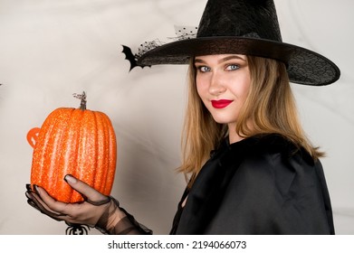 Closeup Halloween Portrait Of Witch Dressed On All Black With Red Lips Preparing To Put Spell.31 October Trick Ot Treat Party