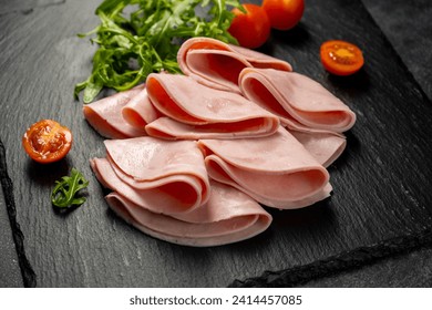 Closeup ham slices, over dark background