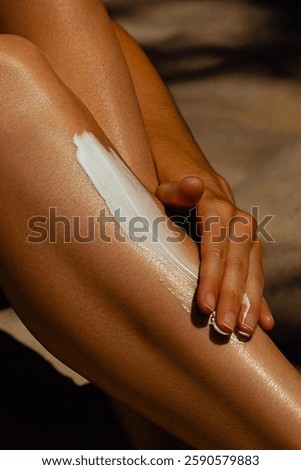 Close-up of hand applying sunscreen on skin outdoors on sunny day. Skin care, sun protection