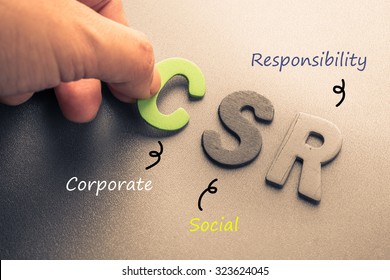 Closeup hand arrange wood letters as CSR abbreviation(Corporate social responsibility)