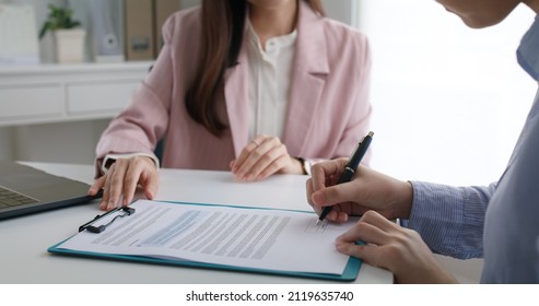 Close-up Hand Asia People Woman Fill Rent Loan Form Write Legal Debt Letter At Lawyer Home Office. Happy Female Life Buy Or Sell New House Deal From Real Estate Sale Agent. Tax Advice Talk And Smile.