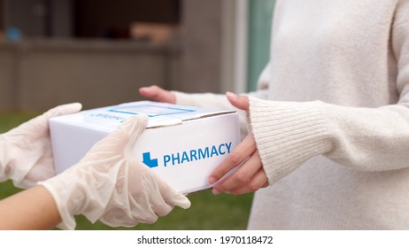Close-up hand asia woman chemist give covid free first aid self recover care kit on desk help customer people buy online clinic retail Rx drug store in telehealth telemedicine e-commerce home order. - Shutterstock ID 1970118472