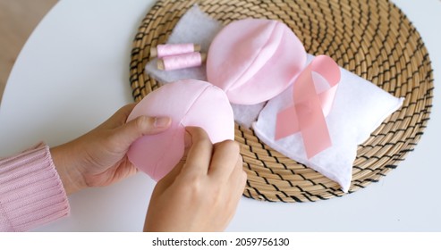 Close-up Hand Asia Woman Help Make Craft Pink Single Fill Up Bra Cup Insert For Post Mastectomy Prosthesis Surgery MRM At Home. Relief Work Service Support Give Hope To Tumor Patient Medical Issue.