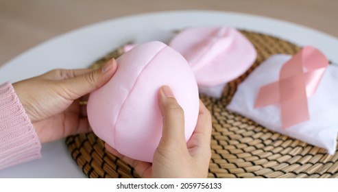 Close-up Hand Asia Woman Help Make Craft Pink Single Fill Up Bra Cup Insert For Post Mastectomy Prosthesis Surgery MRM At Home. Relief Work Service Support Give Hope To Tumor Patient Medical Issue.