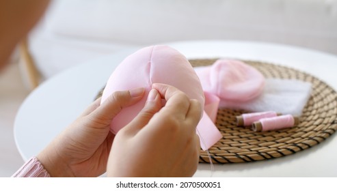 Close-up Hand Asia Woman Help Make Craft Pink Single Fill Up Bra Cup Insert For Post Mastectomy Prosthesis Surgery MRM At Home. Relief Work Service Support Give Hope To Tumor Patient Medical Issue.