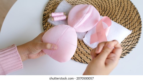 Close-up Hand Asia Woman Help Make Craft Pink Single Fill Up Bra Cup Insert For Post Mastectomy Prosthesis Surgery MRM At Home. Relief Work Service Support Give Hope To Tumor Patient Medical Issue.