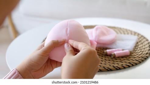 Close-up Hand Asia Woman Help Make Craft Pink Single Fill Up Bra Cup Insert For Post Mastectomy Prosthesis Surgery MRM At Home. Relief Work Service Support Give Hope To Tumor Patient Medical Issue.