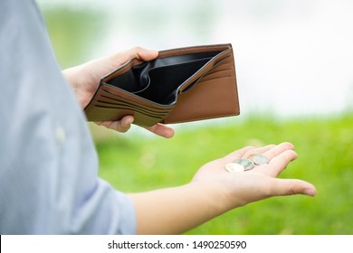 Closeup hand of asian businesswoman hold her wallet,hand open an empty wallet,spend money extravagantly,extravagant people never save money,bad economics situation,poverty,economic depression concept - Shutterstock ID 1490250590